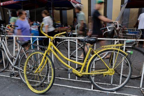 epa12808245 Bicycles are chained to grills at a market district in Quezon City, Metro Manila, Philippines, 10 March 2026. As significant fuel price hikes hit the Philippines 10 March amidst ongoing Middle East tensions from conflict involving the United States, Israel and Iran, bicycles are expected to be used as alternative modes of transport by motorists...