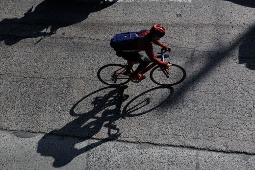 epa12808246 A person on a bicycle travels along a main thoroughfare in Quezon City, Metro Manila, Philippines, 10 March 2026. As significant fuel price hikes hit the Philippines 10 March amidst ongoing Middle East tensions from conflict involving the United States, Israel and Iran, bicycles are expected to be used as alternative modes of transport by...