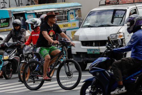 epa12808253 A person on a bicycle crosses an intersection in Quezon City, Metro Manila, Philippines, 10 March 2026. As significant fuel price hikes hit the Philippines 10 March amidst ongoing Middle East tensions from conflict involving the United States, Israel and Iran, bicycles are expected to be used as alternative modes of transport by motorists...