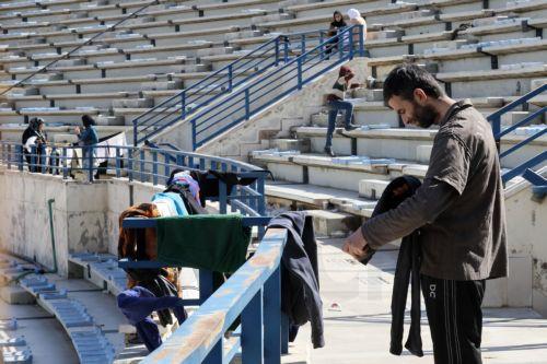 epa12811743 A displaced man waits for laundry to air-dry inside the Camille Chamoun Sports City Stadium in Beirut, Lebanon, 11 March 2026. Lebanese authorities report more than 759,000 registered displaced since the escalation began on 02 March 2026, though the true number is likely higher as many stay with relatives or rent in safer areas.  EPA/WAEL HAMZEH