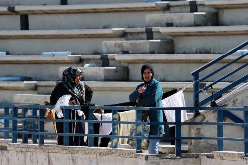 epa12811746 Displaced women wait for laundry to air-dry inside the Camille Chamoun Sports City Stadium in Beirut, Lebanon, 11 March 2026. Lebanese authorities report more than 759,000 registered displaced since the escalation began on 02 March 2026, though the true number is likely higher as many stay with relatives or rent in safer areas.  EPA/WAEL HAMZEH