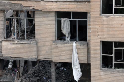 epa12813901 A view of damaged residential buildings in central Tehran, Iran, 12 March 2026. A joint Israeli and US military operation continues to target multiple locations across Iran since the early hours of 28 February 2026.  EPA/ABEDIN TAHERKENAREH