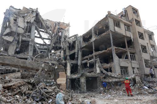epa12813902 Iranian rescue workers work among the rubble of damaged residential buildings in central Tehran, Iran, 12 March 2026. A joint Israeli and US military operation continues to target multiple locations across Iran since the early hours of 28 February 2026.  EPA/ABEDIN TAHERKENAREH
