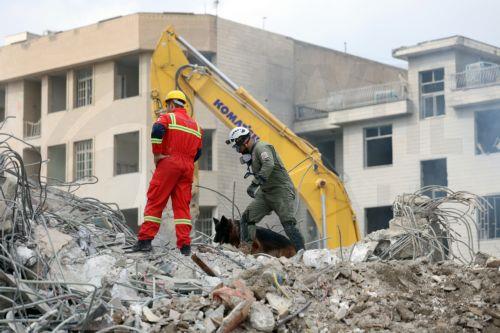 epa12813904 Iranian rescue workers work among the rubble of damaged residential buildings in central Tehran, Iran, 12 March 2026. A joint Israeli and US military operation continues to target multiple locations across Iran since the early hours of 28 February 2026.  EPA/ABEDIN TAHERKENAREH