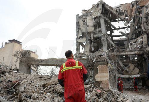 epa12813999 Iranian rescue workers work among the rubble of damaged residential buildings in central Tehran, Iran, 12 March 2026. A joint Israeli and US military operation continues to target multiple locations across Iran since the early hours of 28 February 2026.  EPA/ABEDIN TAHERKENAREH