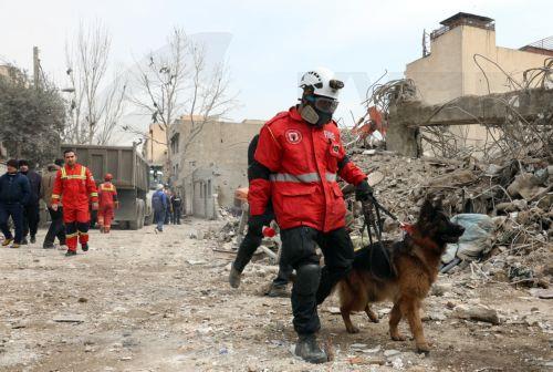 epaselect epa12813793 Iranian rescue workers work among the rubble of damaged residential buildings in central Tehran, Iran, 12 March 2026. A joint Israeli and US military operation continues to target multiple locations across Iran since the early hours of 28 February 2026.  EPA/ABEDIN TAHERKENAREH