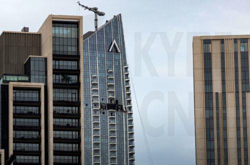 epa12814067 A view of the damaged part of the Dubai Creek Harbour Tower after it was hit by an Iranian drone attack in Dubai, United Arab Emirates, 12 March 2026.  EPA/STRINGER