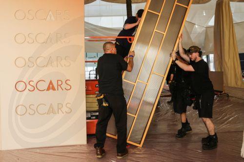 epa12815916 Workers assemble parts of the red carpet backdrop as preparations for the 98th annual Academy Awards ceremony get underway in Los Angeles, California, USA, 12 March 2026. The 98th Academy Awards ceremony will take place at the Dolby Theatre in Los Angeles on 15 March 2026.  EPA/CHRIS TORRES
