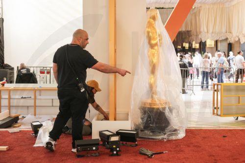 epa12815917 Workers assemble parts of the red carpet backdrop as preparations for the 98th annual Academy Awards ceremony get underway in Los Angeles, California, USA, 12 March 2026. The 98th Academy Awards ceremony will take place at the Dolby Theatre in Los Angeles on 15 March 2026.  EPA/CHRIS TORRES