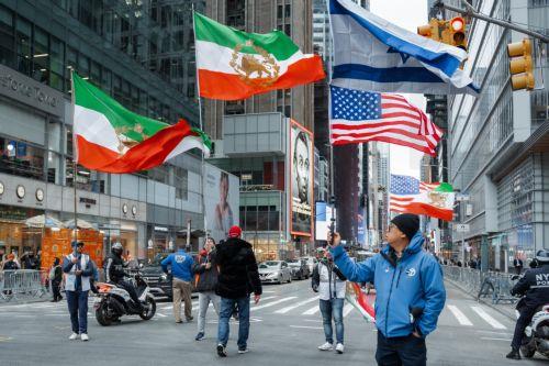 epa12823491 People carry US, Israeli and monarchist Iranian flags during a ‘Freedom for Iran’ protest in New York, New York, USA, 15 March 2026. The rally comes amid ongoing hostilities involving the United States, Israel and Iran.  EPA/OLGA FEDOROVA